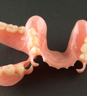 An up-close image of partial dentures made out of gum-colored acrylic and artificial teeth