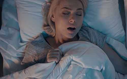 Woman asleep with her mouth open needing airway focused dentistry in Delafield