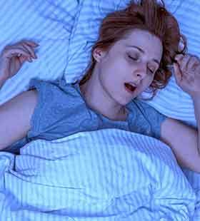 Woman snoring and sleeping with mouth open