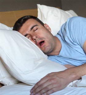 Man snoring while in bed