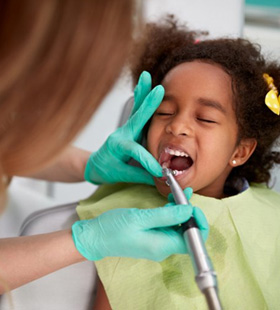 Little girl having her teeth cleaned