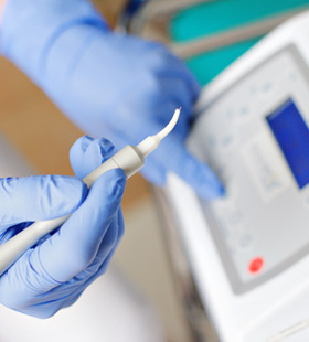 Dentist holding a dental laser