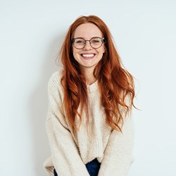 A person cleaning their Invisalign aligners with water