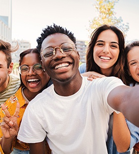 Group of teenagers smiling after Invisalign Teen